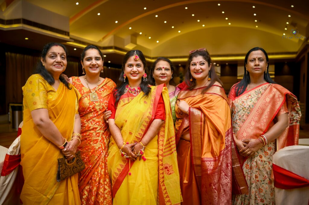 Women in colorful saris celebrate a traditional Indian wedding ceremony in Kolkata.